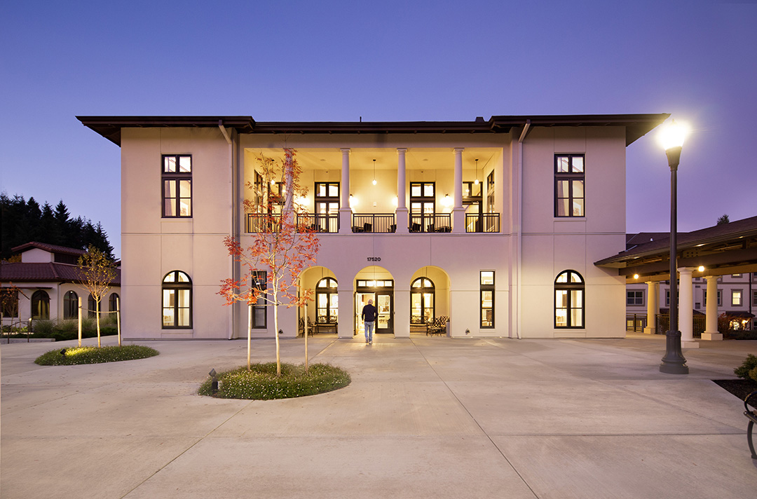 straight shot of building with arched doorways at dusk
