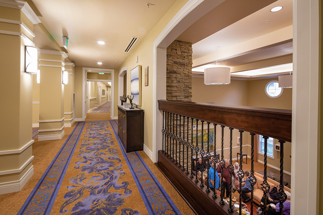 second floor hallway interior shot with view of residents on ground level